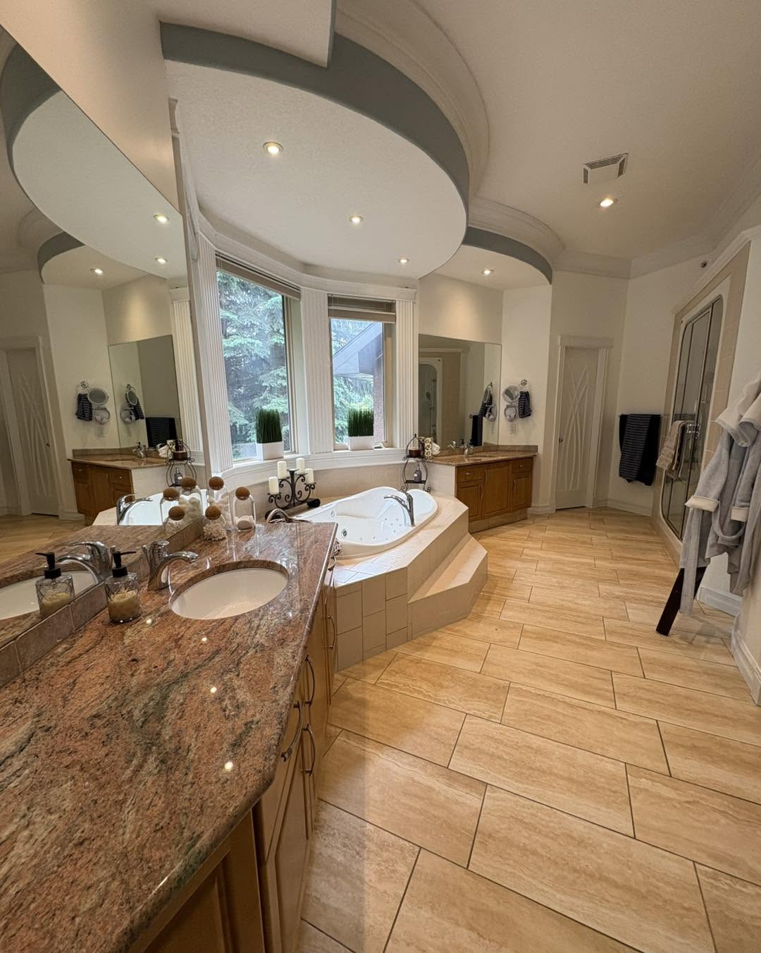 Luxury bathroom with hardwood floors and corner soaking tub
