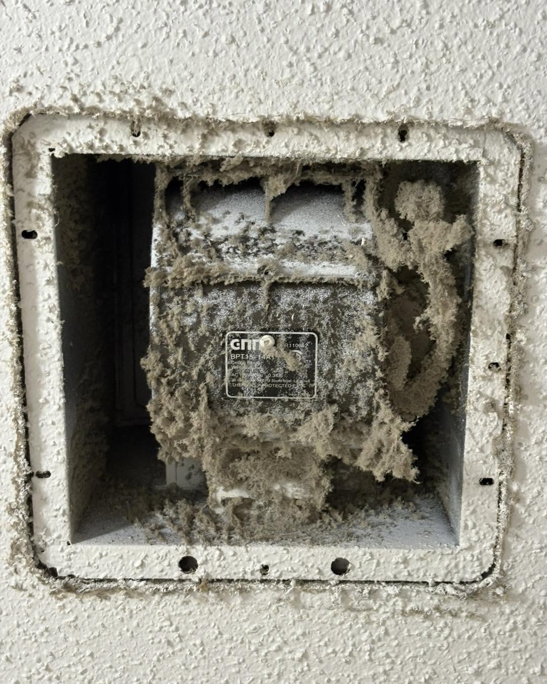 Exhaust fan caked in dust and lint before deep clean
